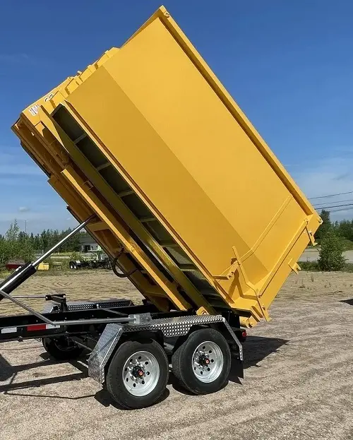 Malabar roll-off dumpster is lifted into unloading position on a tilt trailer operated by Space Coast Dumpster Rental