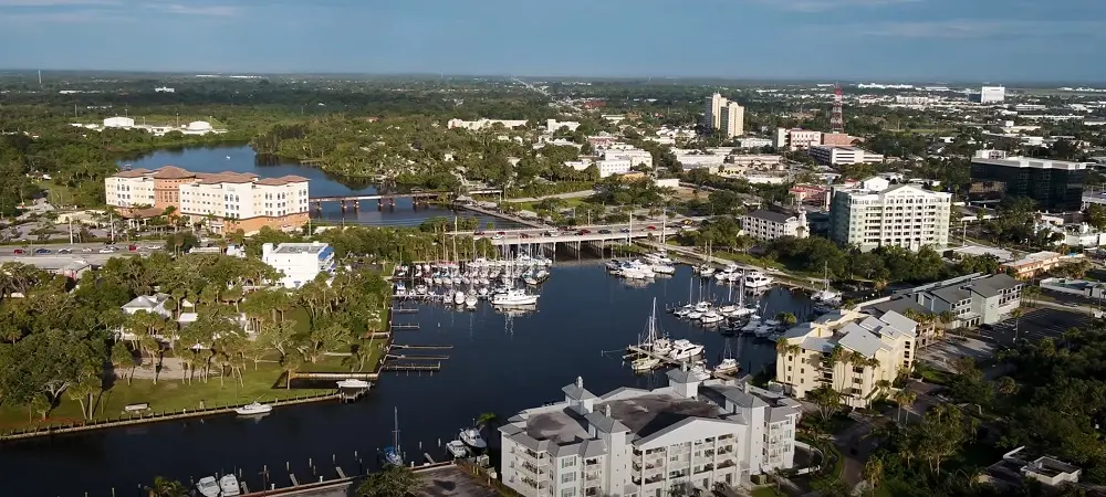 Melbourne captures a marina bordered by mid-rise buildings as boats gather along the harbor, photographed by Space Coast Dumpster Rental