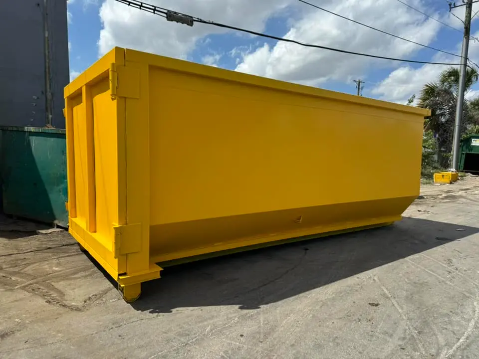 Residential dumpster rental by Space Coast delivers empty yellow dumpster to residential street