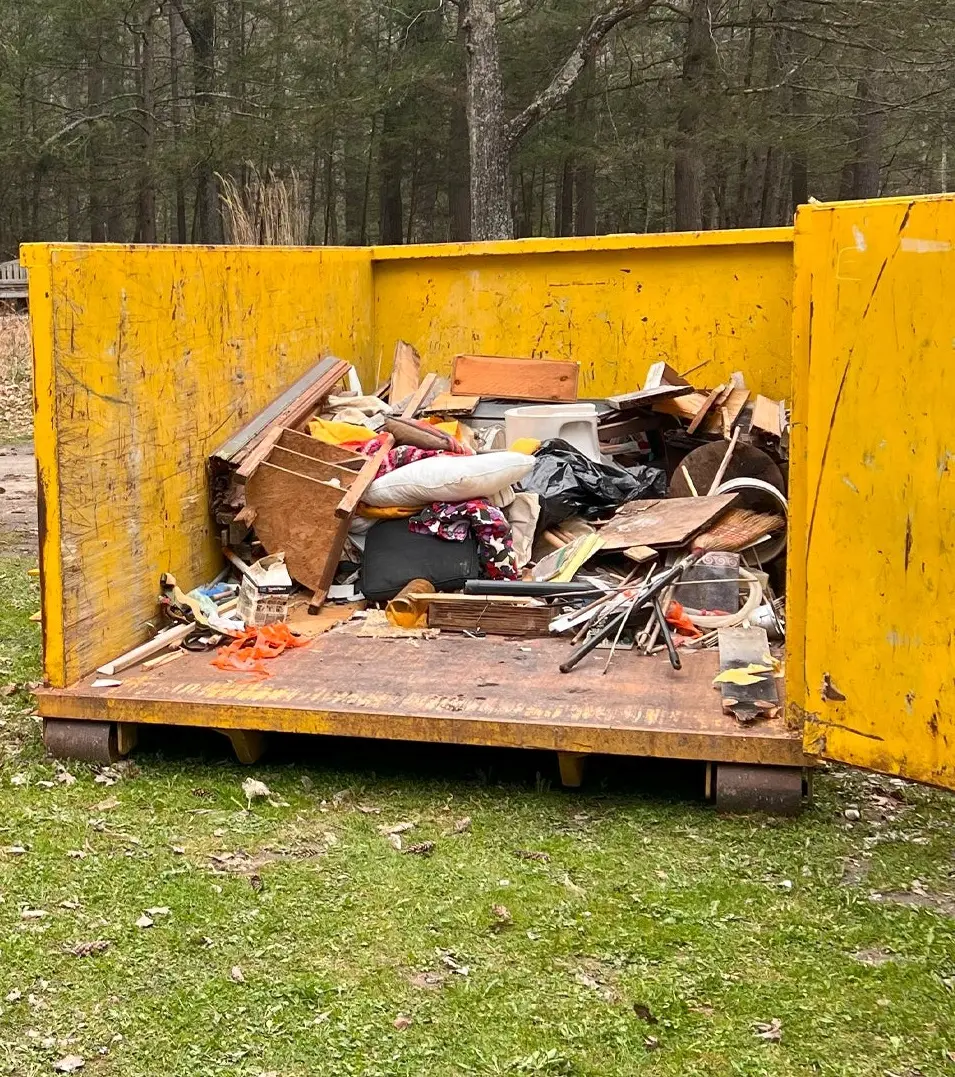 Residential dumpster rental by Space Coast filled yellow dumpster with debris from home cleanout