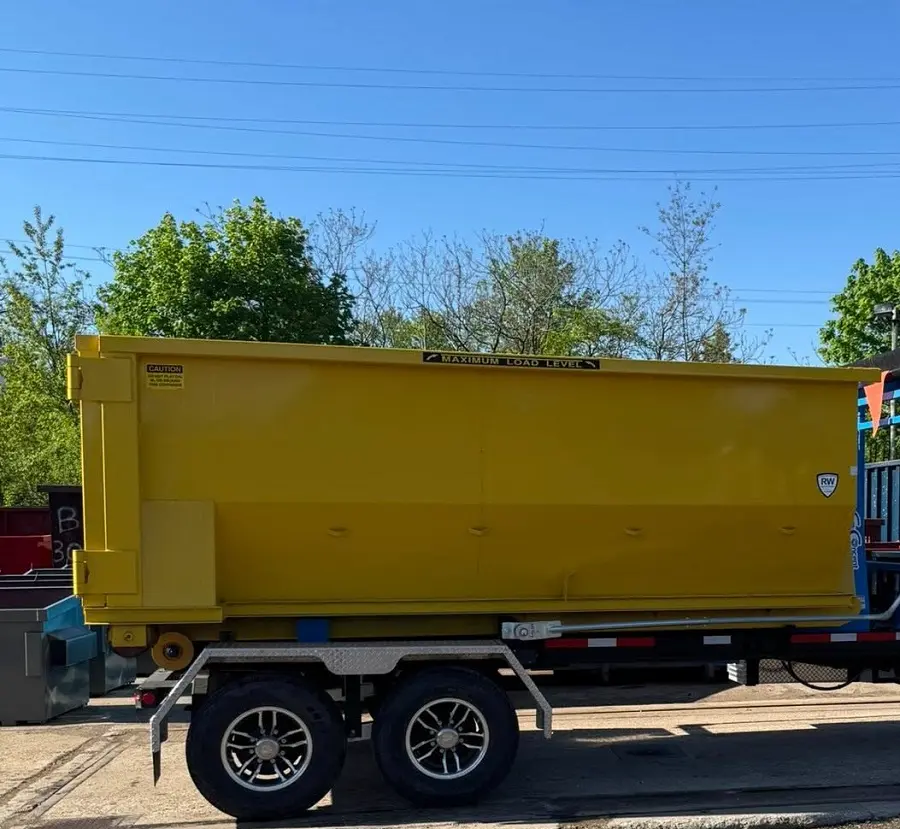 Residential dumpster rental by Space Coast moves yellow rolloff for home renovation cleanup