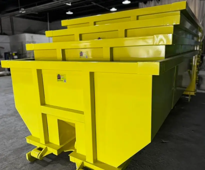 Space Coast Dumpster Rental yellow dumpsters neatly arranged indoors for upcoming delivery needs