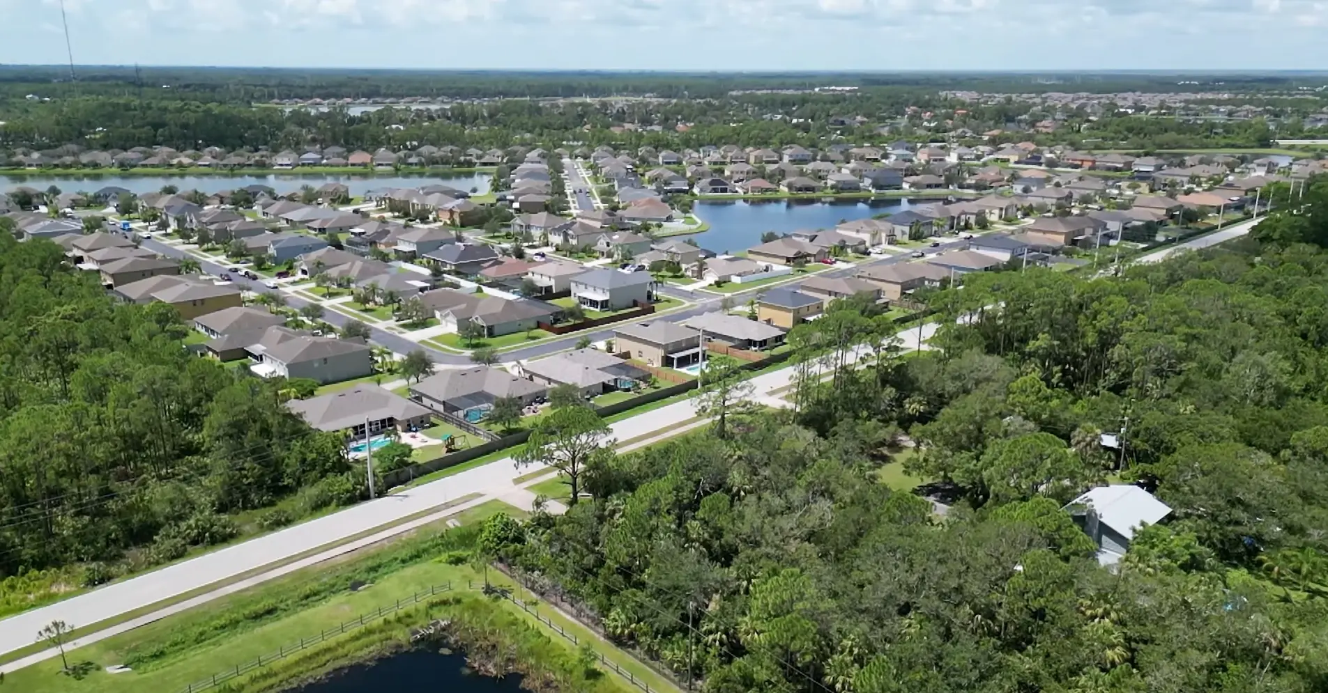 West Melbourne reveals a suburban neighborhood of single-family homes arranged around ponds and roadways, photographed by Space Coast Dumpster Rental